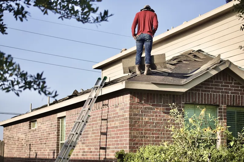Professional roofer working on a residential roof in Viewpoint